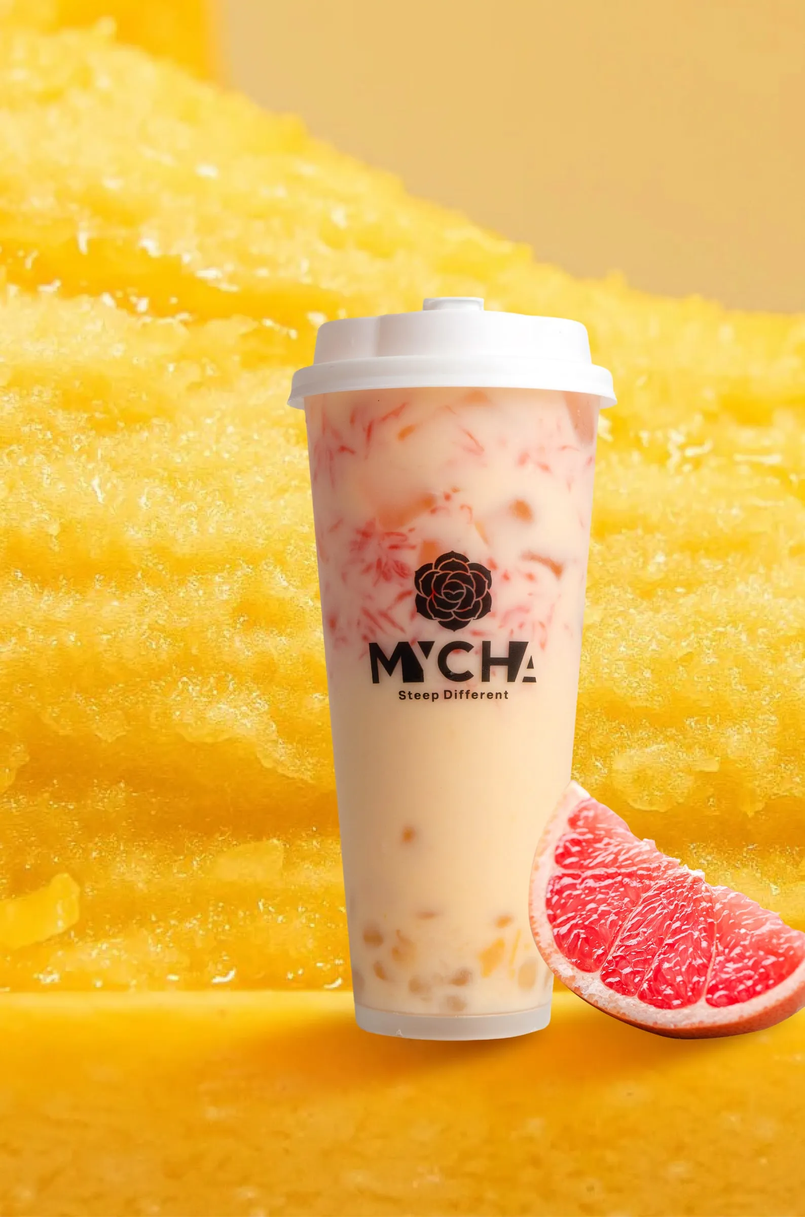 A MYCHA mango pomelo sago with grapefruit and sago against a cut mango ground