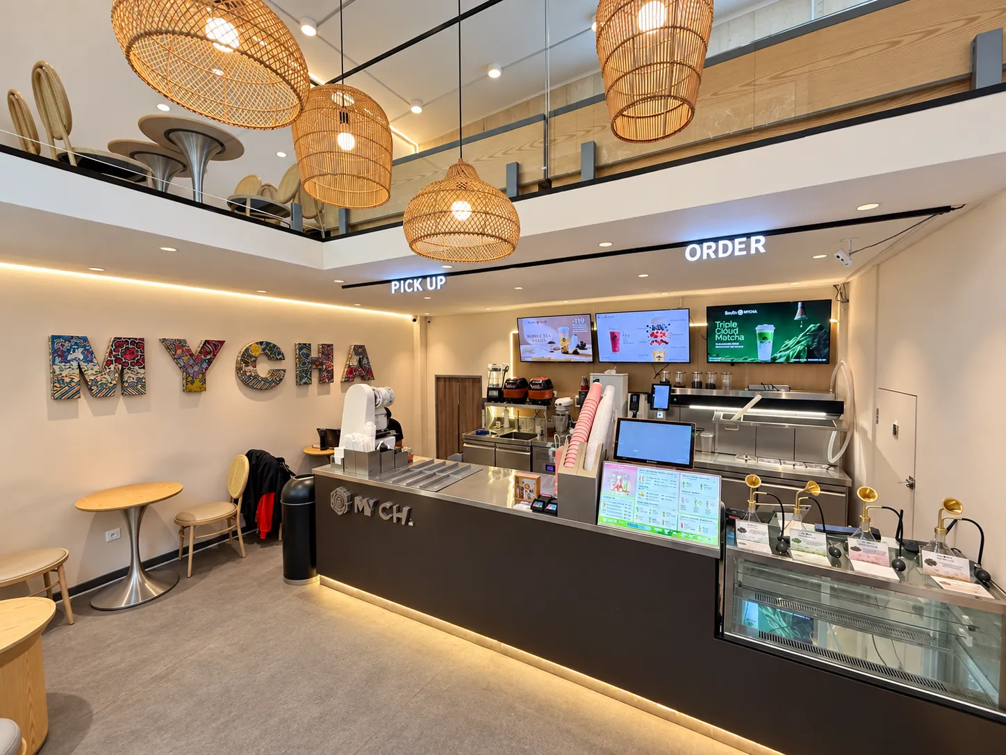 MYCHA interior with woven pendant lights and mezzanine seating above the counter