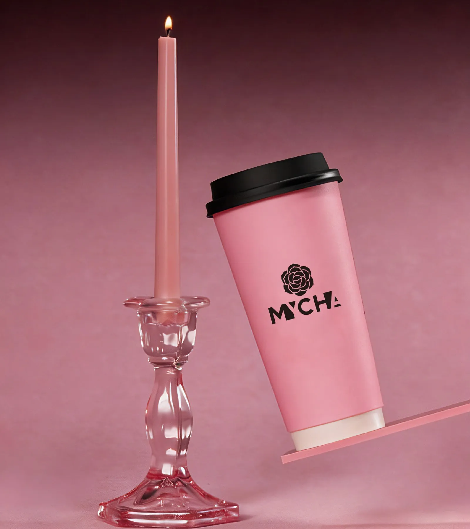 A pink MYCHA cup tilted against a pink candlestick