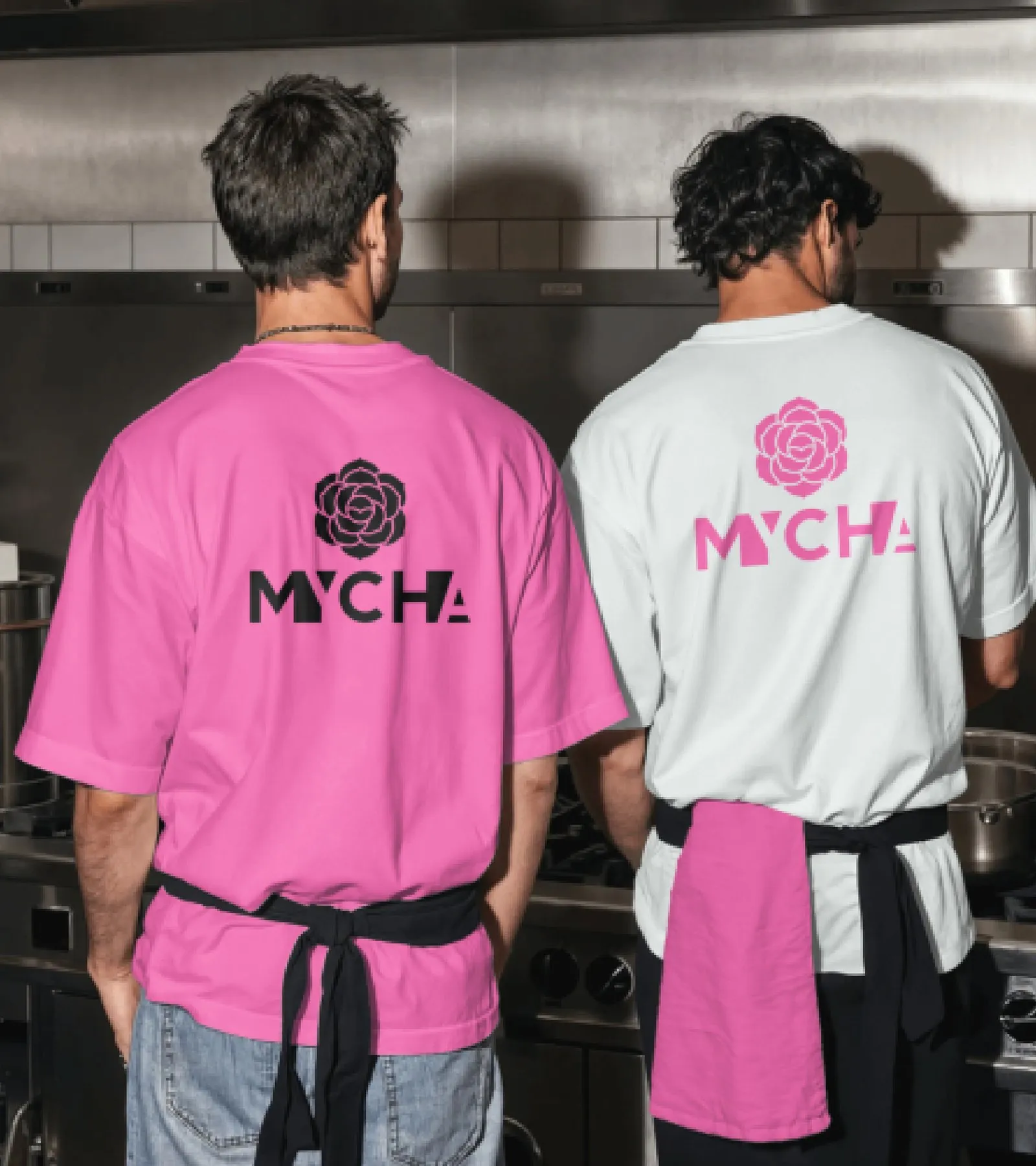 Two staff from behind in pink and white MYCHA T-shirts