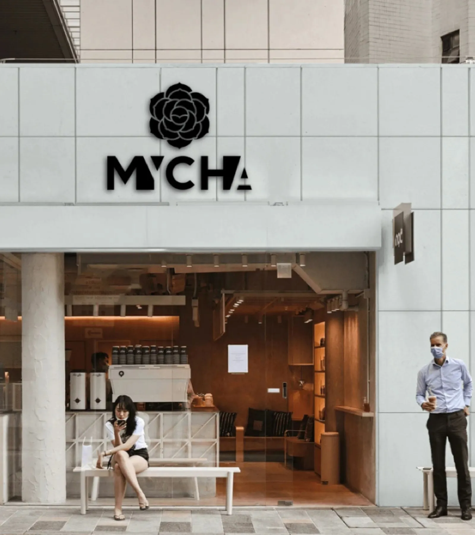 A MYCHA store with light-stone cladding and a warm wooden interior seen through glass