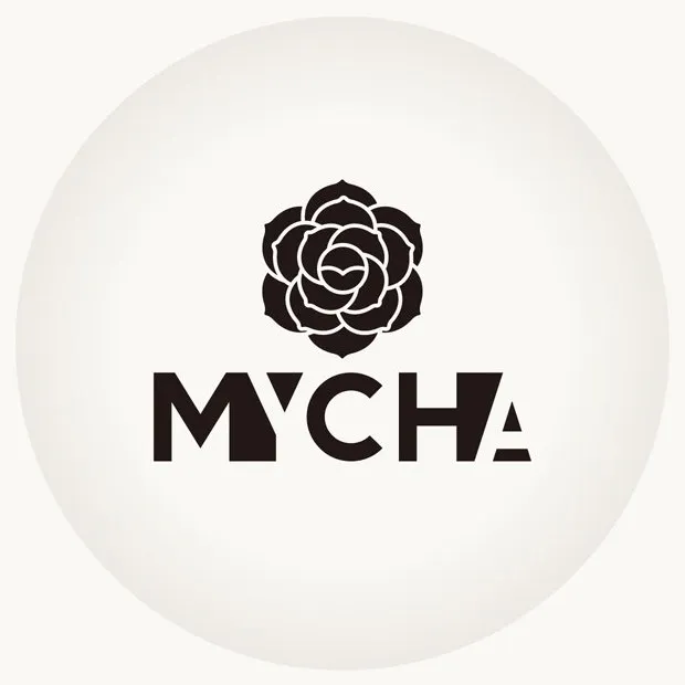 The MYCHA camellia and wordmark on a soft white sphere