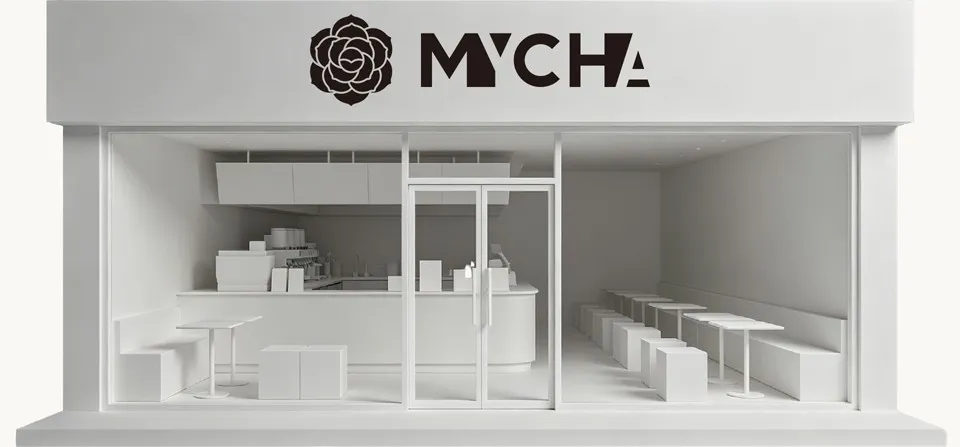 A white scale model of a MYCHA store: the counter, shelves and seating behind the glass front
